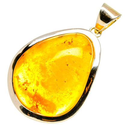 Amber teardrop pendant in silver bezel with gold-tone top bail
