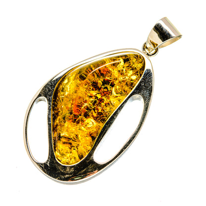 Amber teardrop pendant with oval 925 sterling silver setting and gold-tone bail