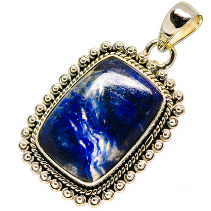 Sodalite pendant in ornate sterling silver frame with top bail and blue cabochon