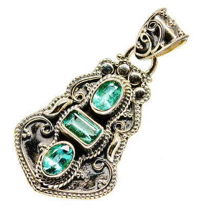 Sterling silver pendant with three green emerald-style stones in ornate oval and bar settings