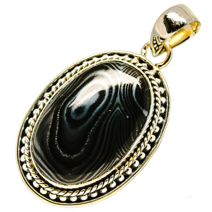 Oval black psilomelane pendant in ornate silver frame with top loop bail