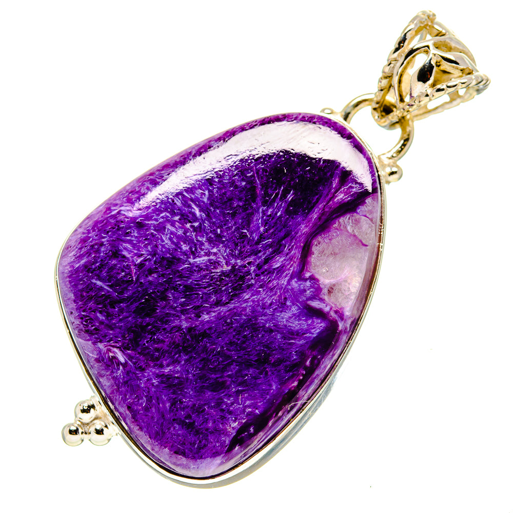 Purple charoite teardrop pendant with ornate gold-tone bail, silver edging