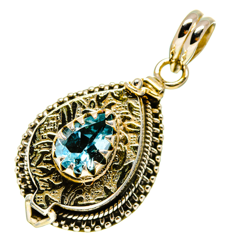 Blue topaz-style pendant with ornate silver-tone bezel and teardrop bail, gold accents