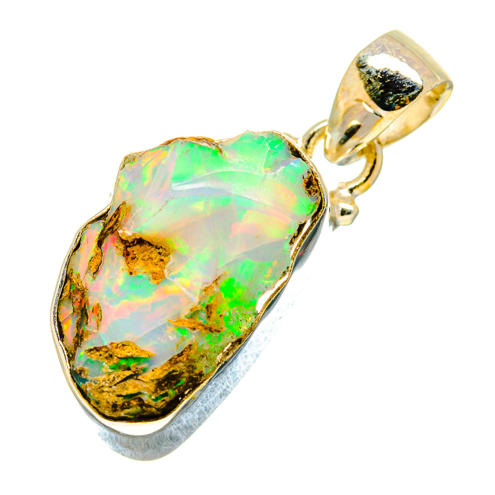 Sterling silver rough opal pendant with green iridescent stone, oval bezel and bail