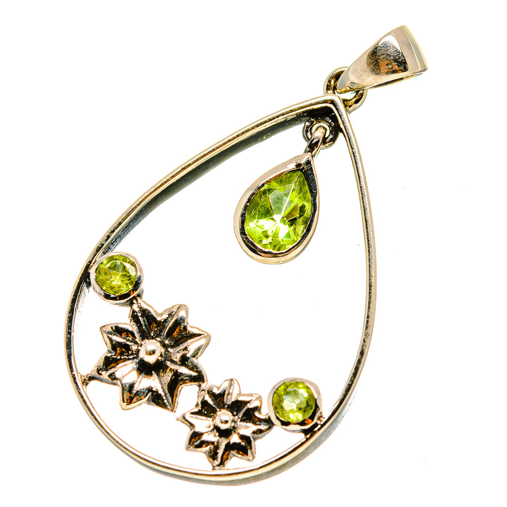 Silver-tone teardrop pendant with green peridot stones and star accents