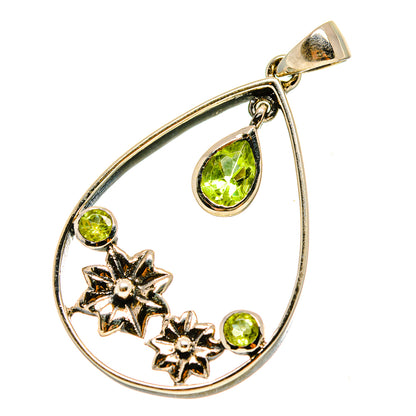 Silver-tone teardrop pendant with green peridot stones and star accents