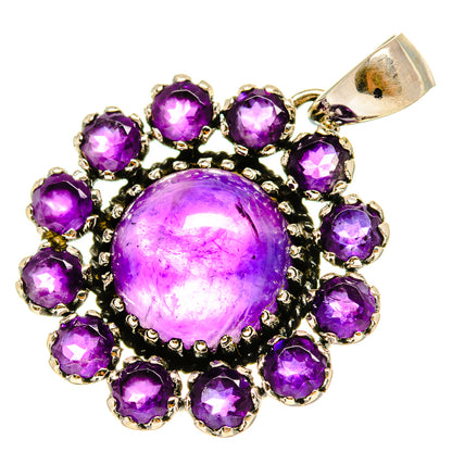 Amethyst pendant with a domed purple center gemstone and surrounding round stones in silver