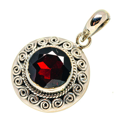 Round sterling silver pendant with red garnet cabochon and ornate filigree bezel