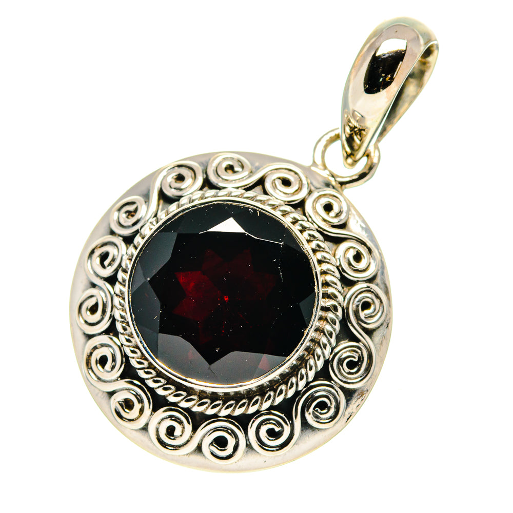Round garnet pendant with decorative swirl border and black-red gemstone in sterling silver