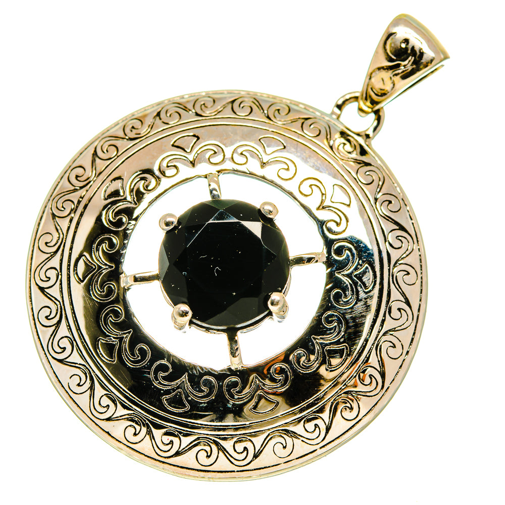Round black onyx pendant with ornate silver filigree and prong bezel, gold-toned bail