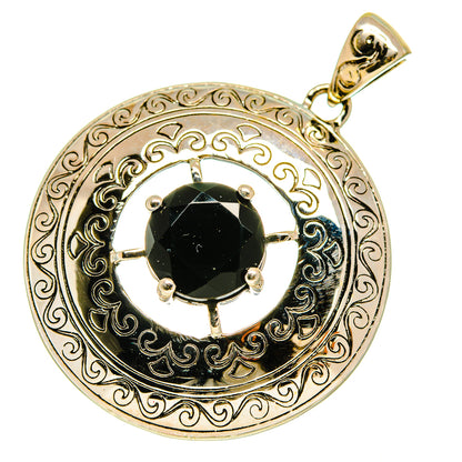 Round black onyx pendant with ornate silver filigree and prong bezel, gold-toned bail