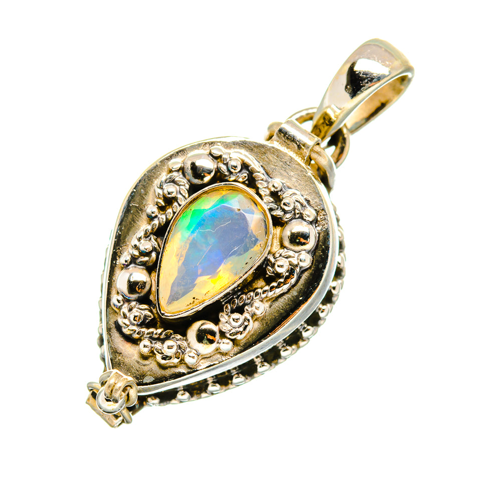 Sterling silver opal pendant with faceted oval center, ornate bezel, and bail
