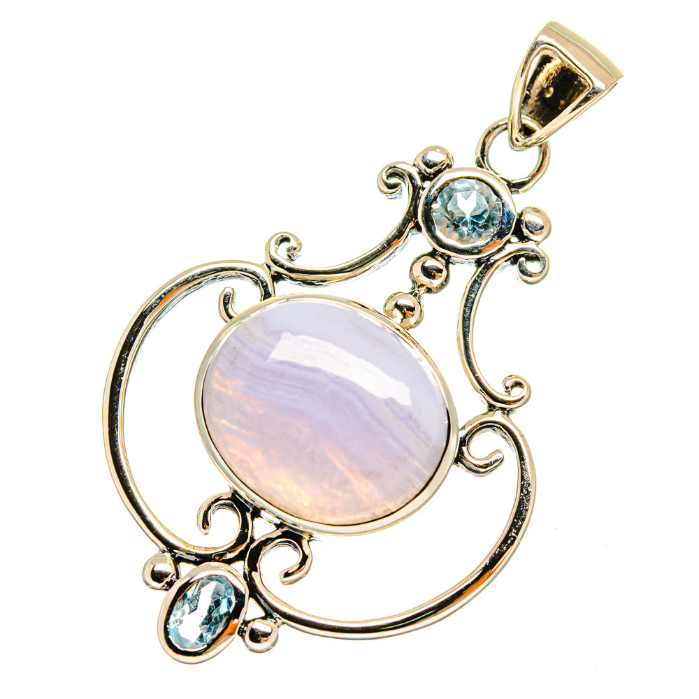 Sterling silver pendant with round opalescent cabochon and blue topaz-like stones