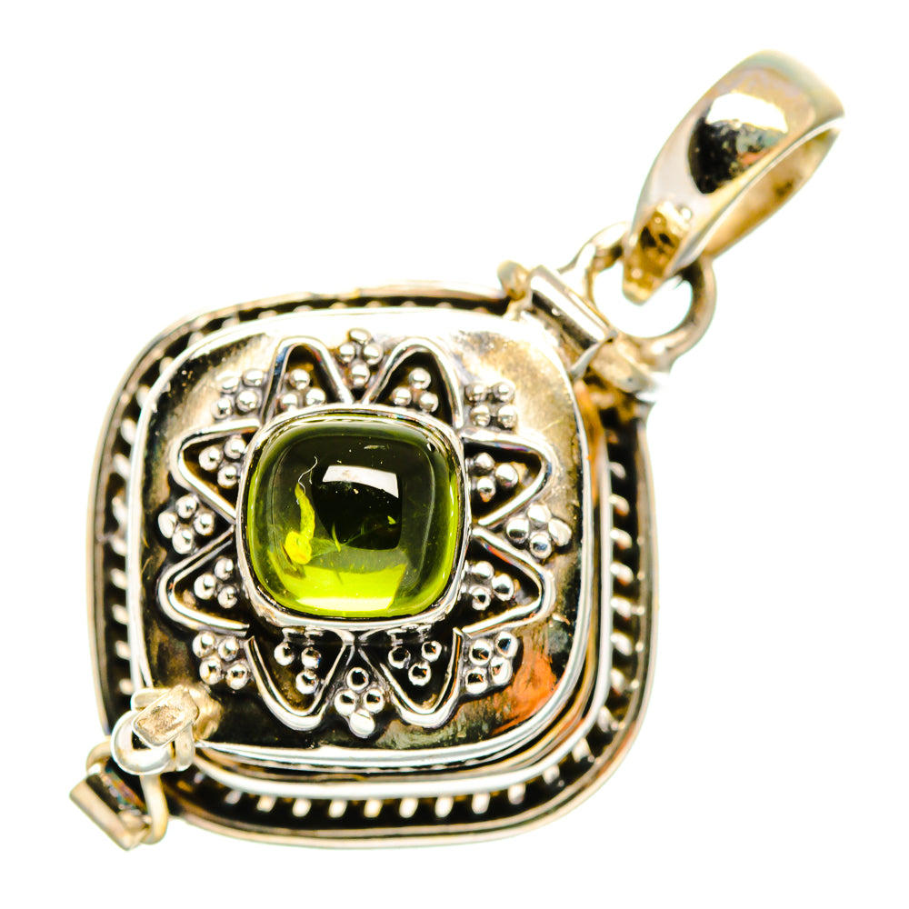 Sterling silver pendant with green square-cut gemstone in filigree frame and bail loop.