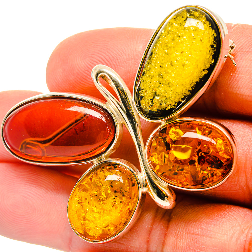 Amber brooch pin on finger, three teardrop stones in 925 sterling silver setting