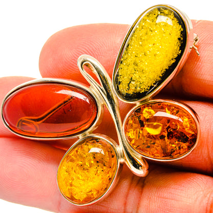 Amber brooch pin on finger, three teardrop stones in 925 sterling silver setting