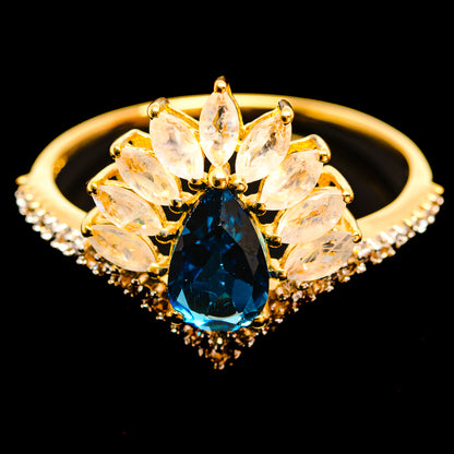 14K yellow gold ring with oval blue faceted center and clear marquise halo