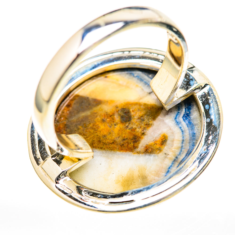 Sterling silver ring showcasing blue-and-yellow scheelite oval cabochon in raised bezel