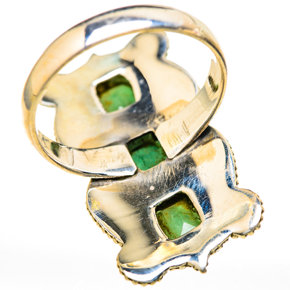 Metallic ring with emerald-green rectangular gemstones and raised prongs