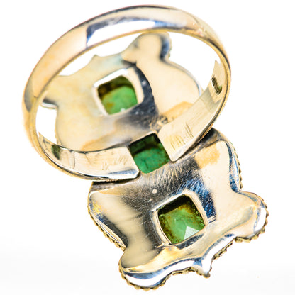 Metallic ring with emerald-green rectangular gemstones and raised prongs