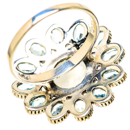 Metallic band ring with raised blue stone settings and ornate side filigree details