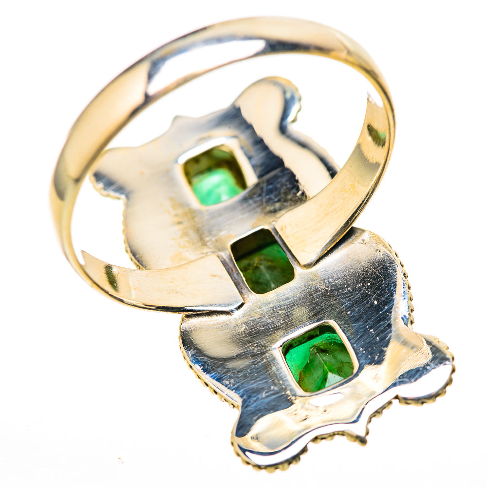 Gold-tone ring with three small green rectangular stones in a cutout X-style design