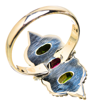 Sterling silver ring with blue, green, and red faceted oval stones and gold-toned band
