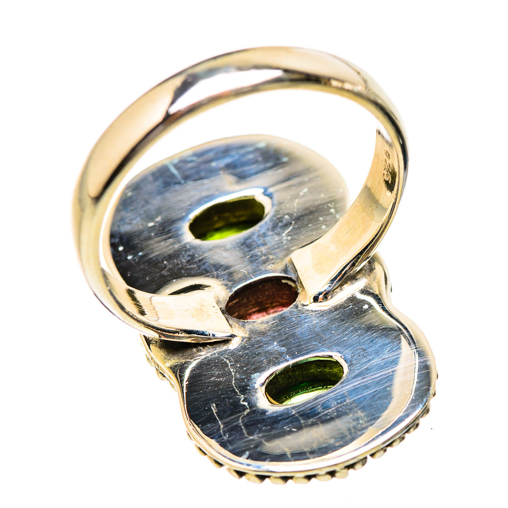 Gold-tone ring with oval cabochon insets showing blue-gray and green reflections