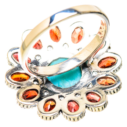 Sterling silver ring with turquoise center and red garnet stones, oval top view