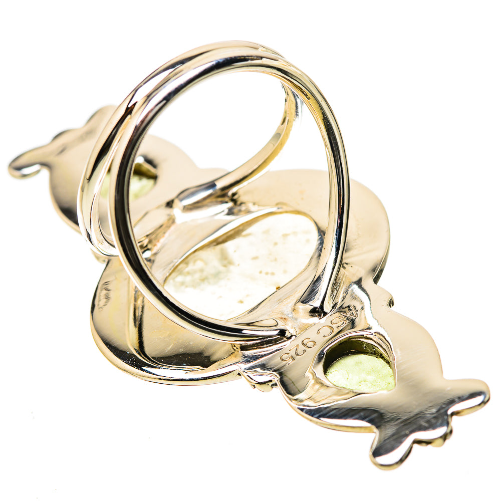 Sterling silver ring with large oval yellowish gemstone bezel and openwork side guards