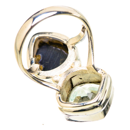 Sterling silver ring showing underside of dark oval and small faceted light gemstone