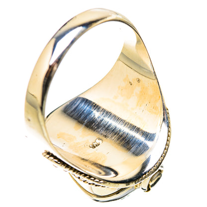 Silver-tone filigree ring with blue teardrop gemstone, ornate bezel detail