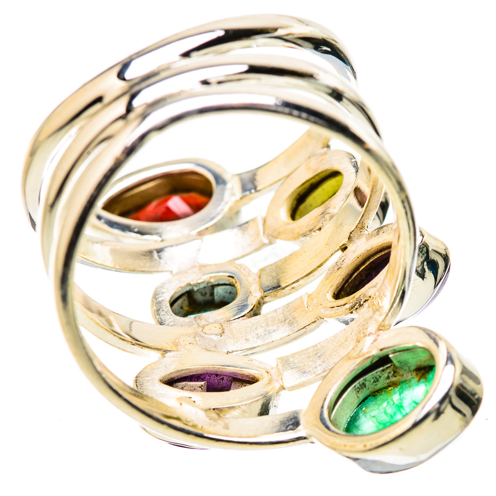 Silver swirl ring with prong-set green and purple gemstones visible along the band