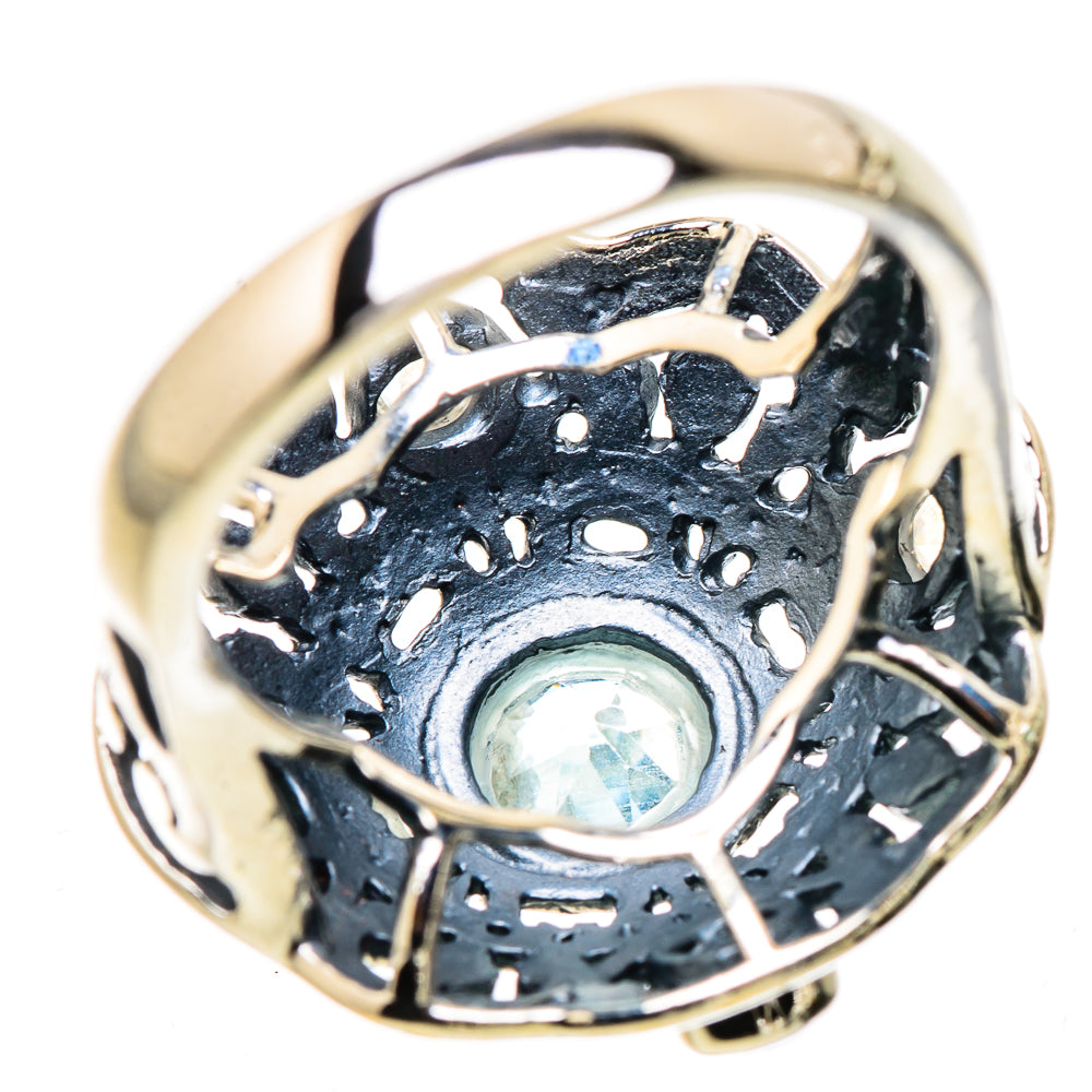 Sterling silver filigree ring with round light-blue gemstone in ornate band