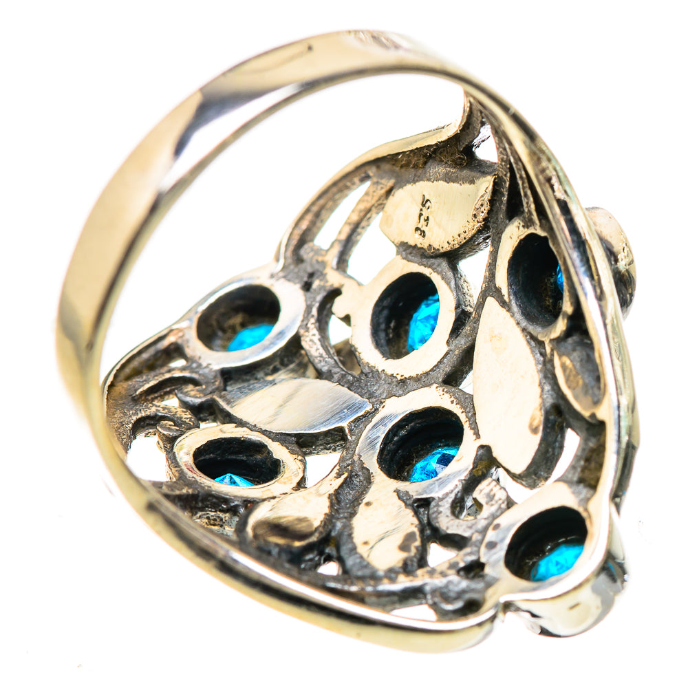 Openwork silver ring with circular blue accents along the band