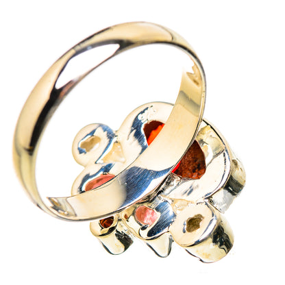 Gold-tone ring with oval red gemstone and blue/pink inlay