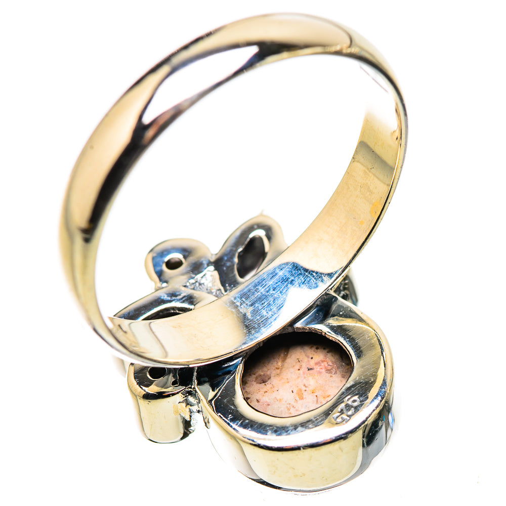Sterling silver ring with large orange gemstone and clear faceted accents
