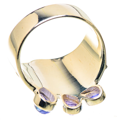 Sterling silver band ring with purple faceted stones on the lower bezel