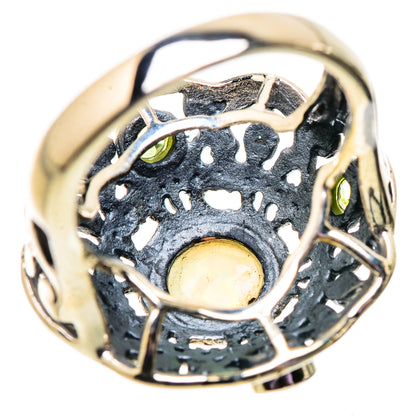 Sterling silver filigree ring with pale opal center and green peridot accents