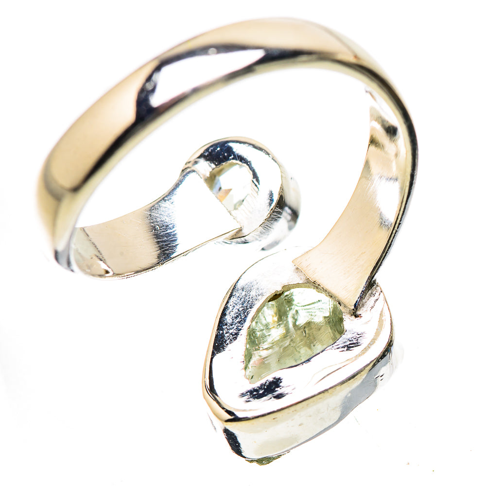 Sterling silver ring with green teardrop and clear round gemstones on an open band