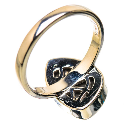 Polished sterling silver ring with blue iridescent ammolite bezel