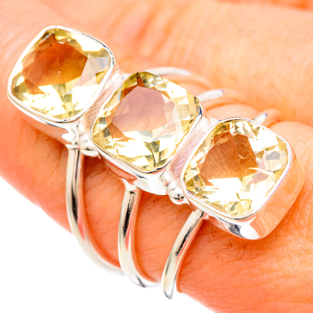 Silver ring with three faceted citrine oval gemstones in bezel settings
