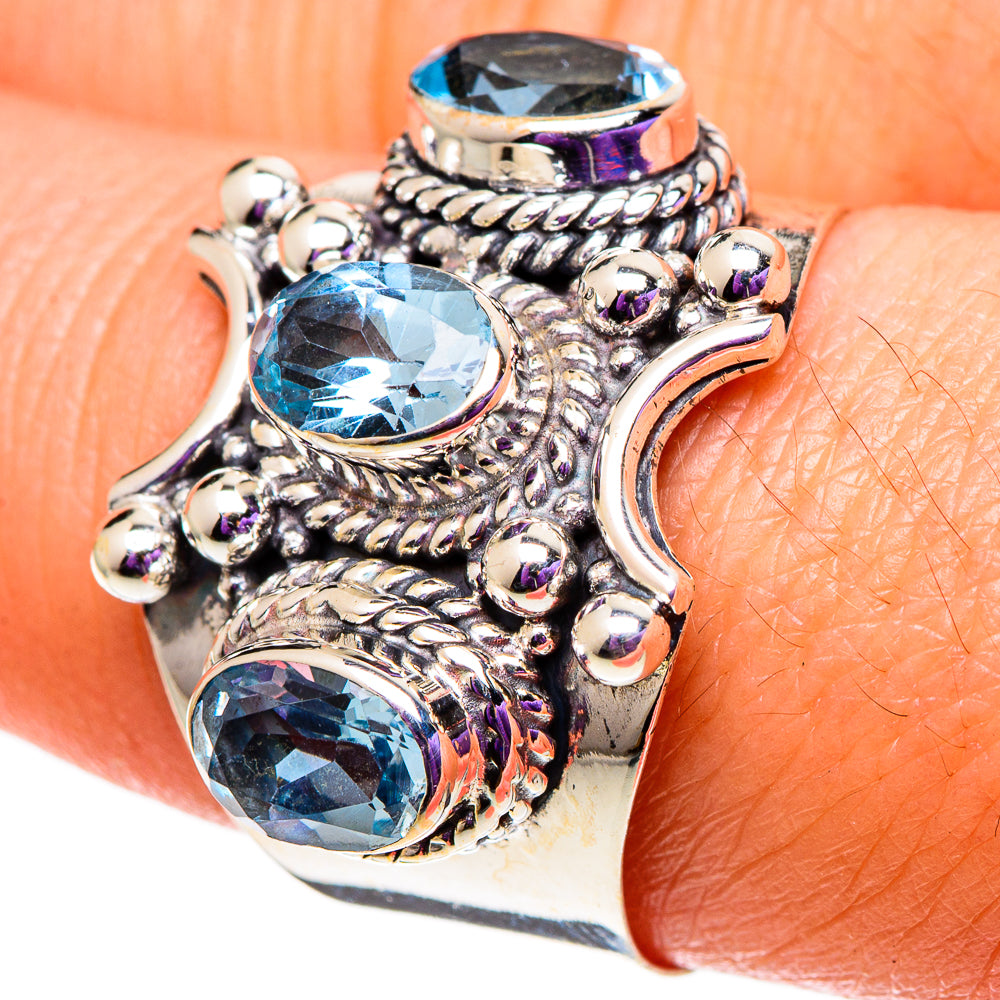 Sterling silver blue topaz ring, size 9.5, close-up of textured prongs and three blue stones