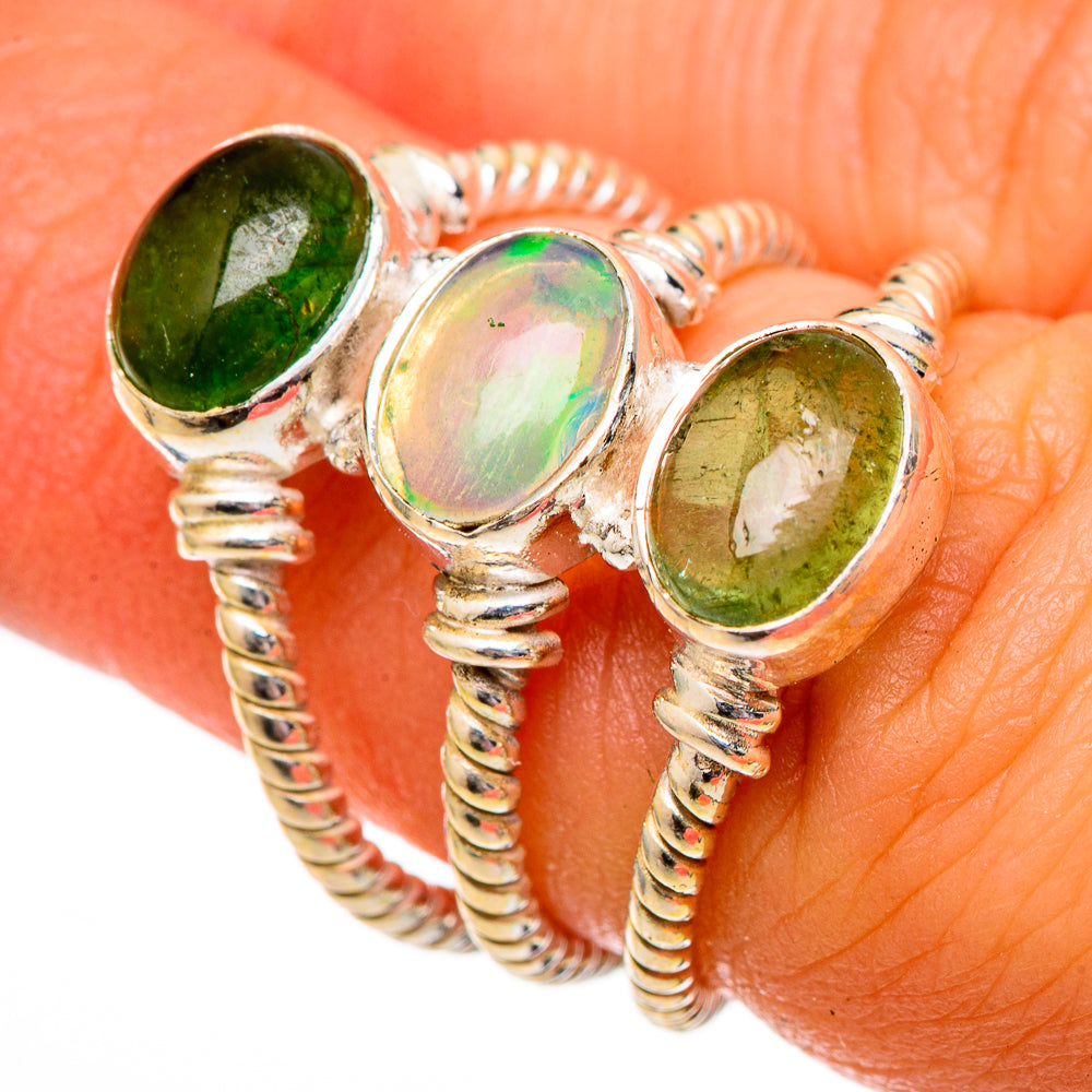 Sterling silver ring with three oval green stones and an iridescent center gemstone
