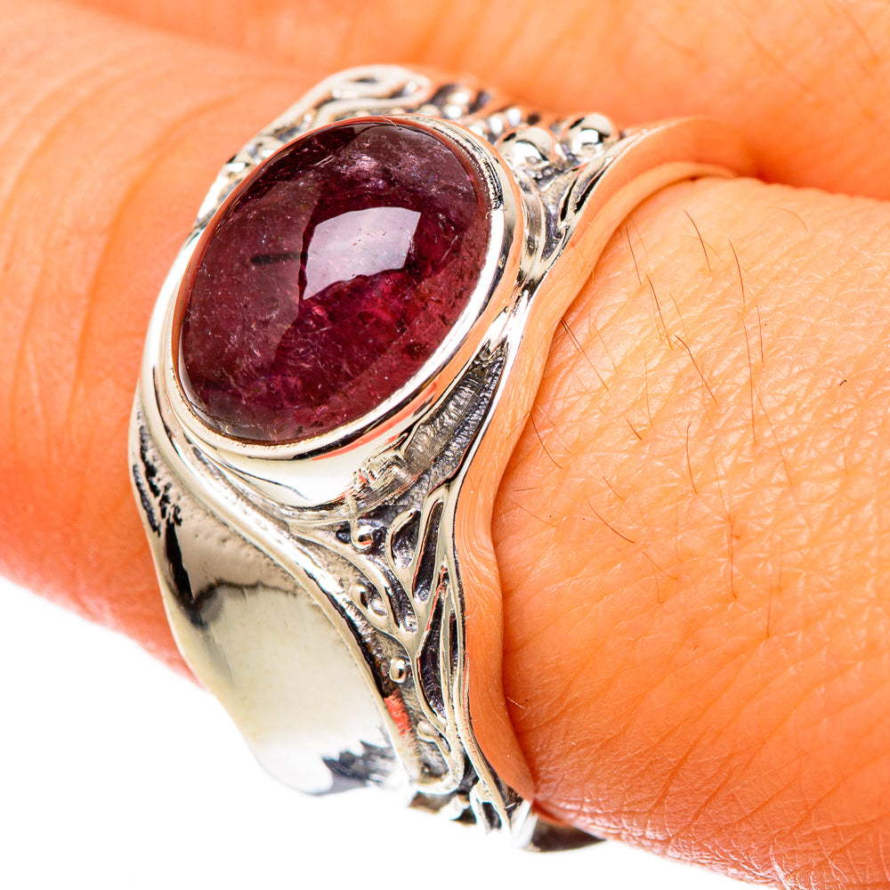 Sterling silver ring close-up with oval pink tourmaline and ornate side engravings