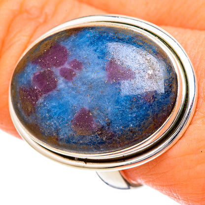 Oval cabochon ring with blue and purple mottled stone set in polished silver bezel