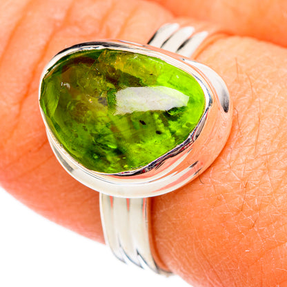 Sterling silver ring with oval green peridot gemstone, high-polish bezel setting