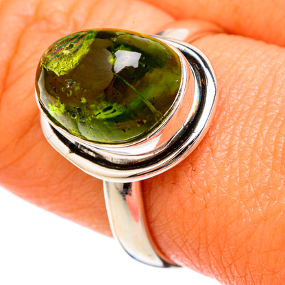 Sterling silver ring with oval green tourmaline cabochon, faceted bezel