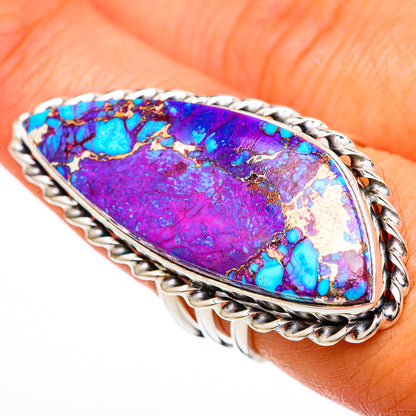 Large purple-blue turquoise inlay ring with braided silver band on a finger