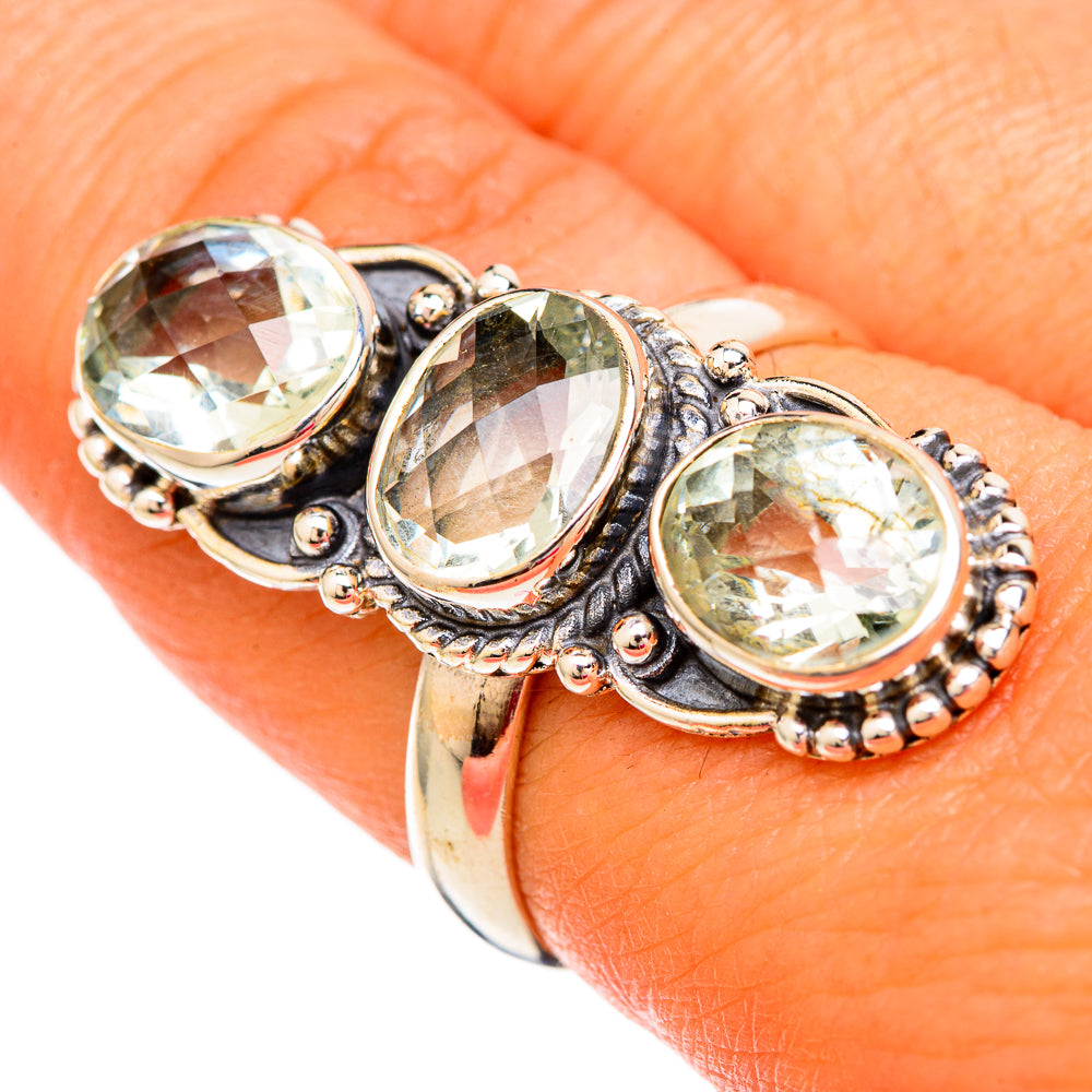 Sterling silver amethyst ring on hand, three faceted oval stones in textured bezel